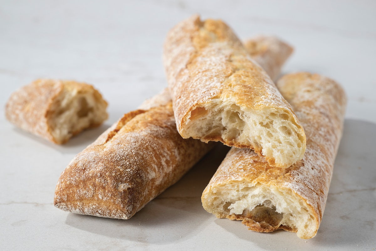 Pile of Baguettes with One Bite Missing